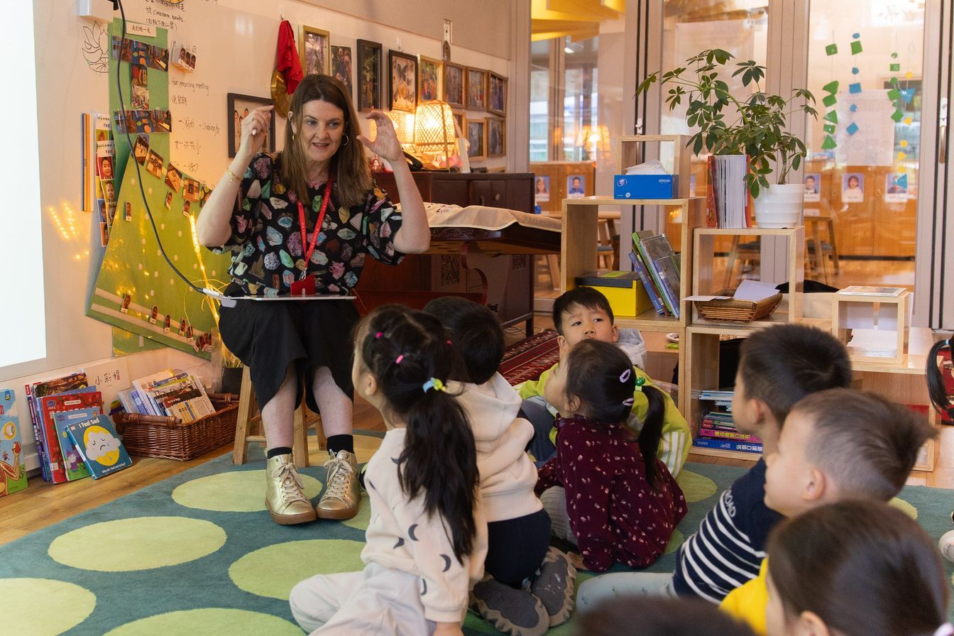 A visiting author talks to children during ISB's Book Week 2025