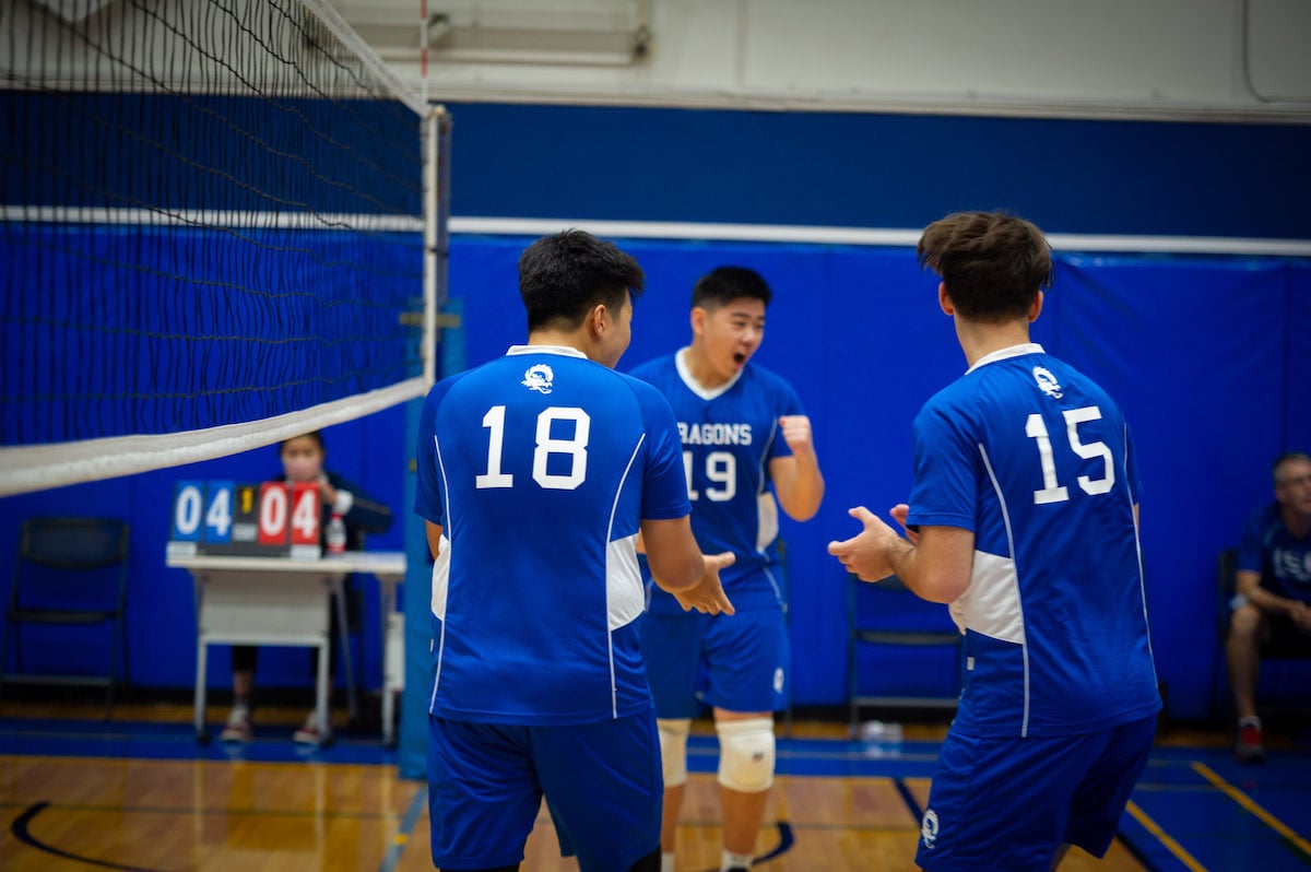 ISB HS volleyball players celebrating