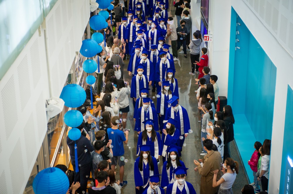 Overhead shot of students in graduation gowns walking in the 2022 Seniors Parade