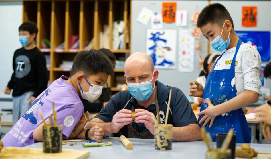 Students and a teacher working on an art project