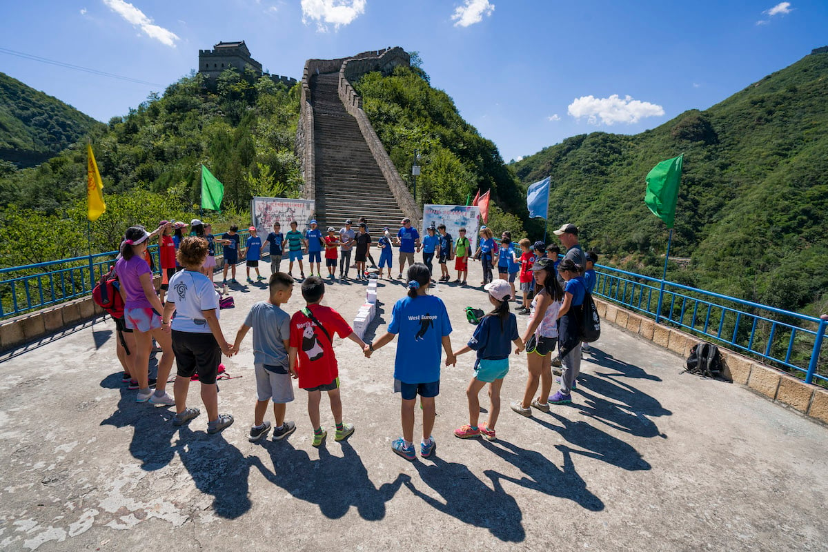 Students gather in a circle on the Great Wall of China