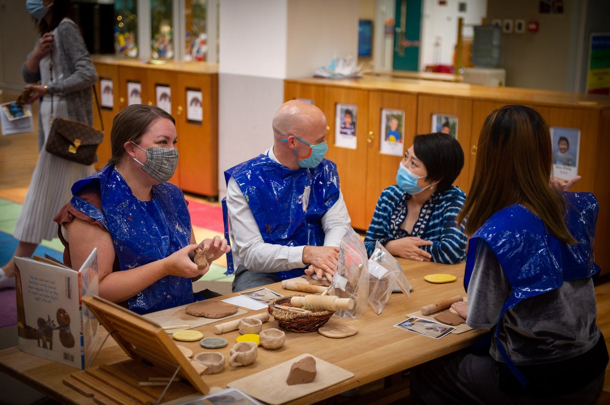 Parents doing a craft activity in an Elementary School classroom