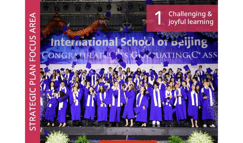 Students in graduation gowns on stage at ISB's Graduation Ceremony