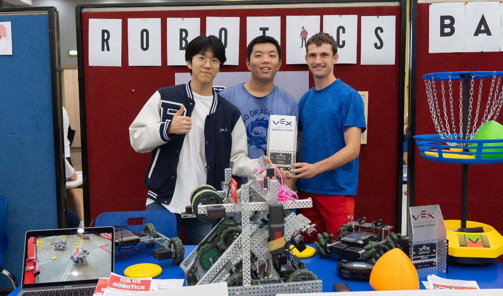 Students with robots at the Robotics Club booth at the Club Fair