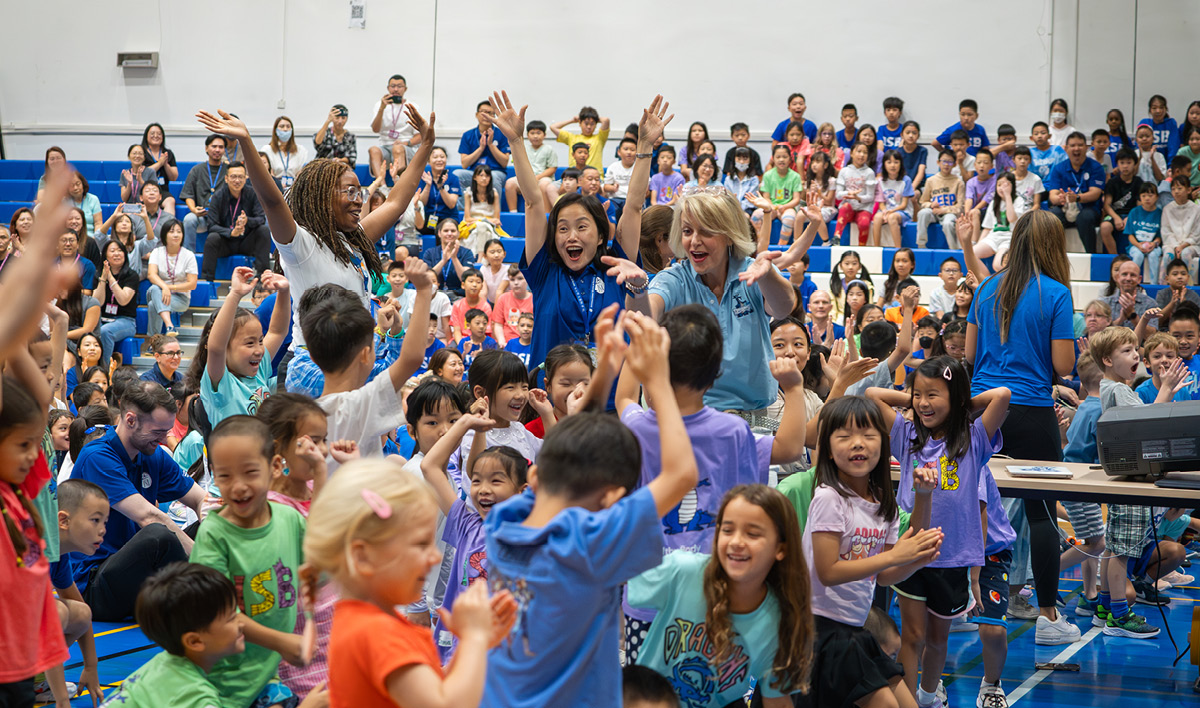 ISB Elementary School students and teacher dancing during an assembly