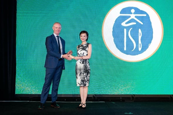 ISB's Cissy Mu receiving an award on stage