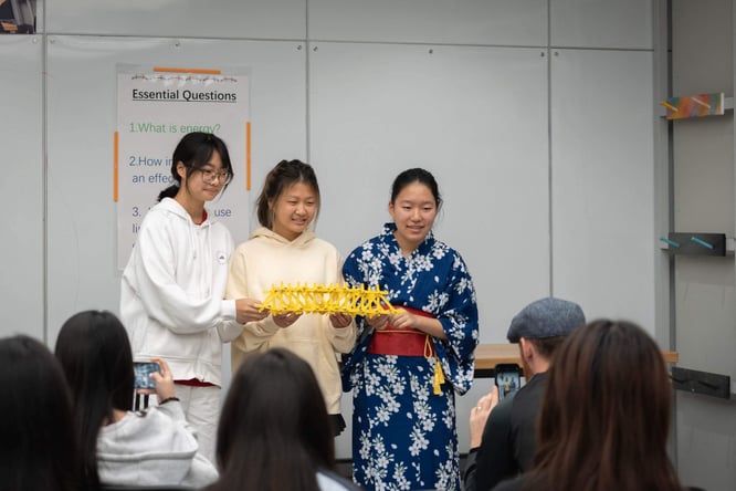 Students displaying a bridge building project