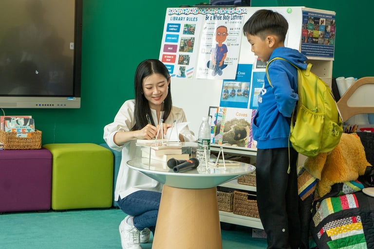 Alumni author Amélie Wen Zhao signs an autograph while on a visit to ISB